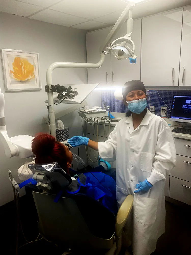Dental assistant working with a patient
