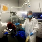 Dental assistant working with a patient