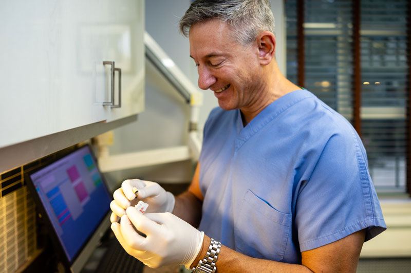 Dr. Kirsch smiling while working