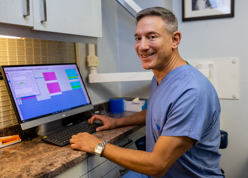 Dr. Kirsch sitting at a computer